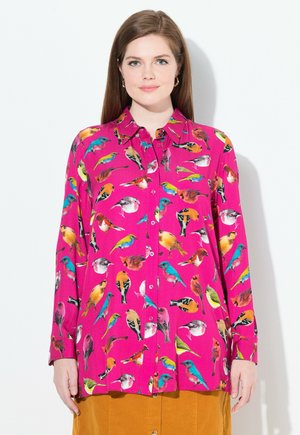 Bright pink long-sleeve shirt featuring a colorful bird print, with a button-front design and classic collar. Smooth fabric texture.