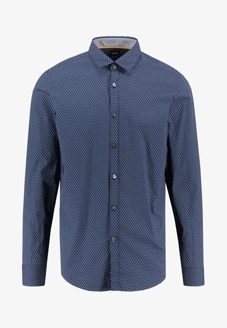 Chemise bleue à manches longues avec petit motif circulaire et col classique, présentée sur un fond blanc uni.