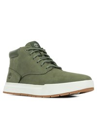 Green suede high-top sneakers with white rubber sole and gum outsole. Features matching laces and Timberland logo on the side.