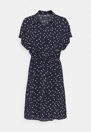 Robe marine à pois blancs, à manches courtes, avec un devant à boutons et une taille nouée. Tissu doux avec une silhouette décontractée.