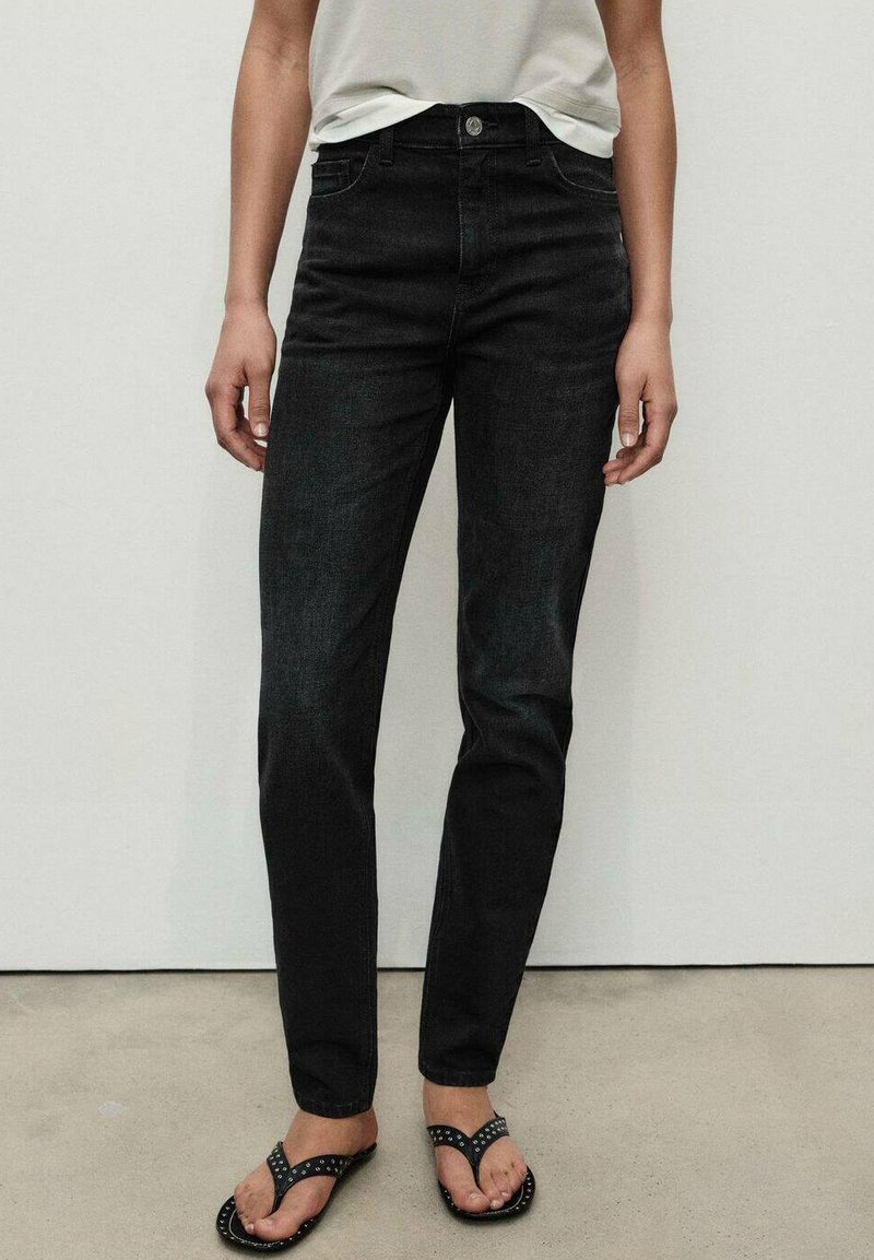 Black denim jeans with a fitted design, five-pocket style, and a button closure. Smooth texture with minimal fading details.