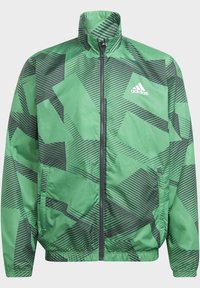 Veste Adidas verte avec des motifs géométriques noirs, fermeture éclair intégrale à l'avant, ourlet et poignets élastiques, et logo Adidas sur la poitrine gauche.