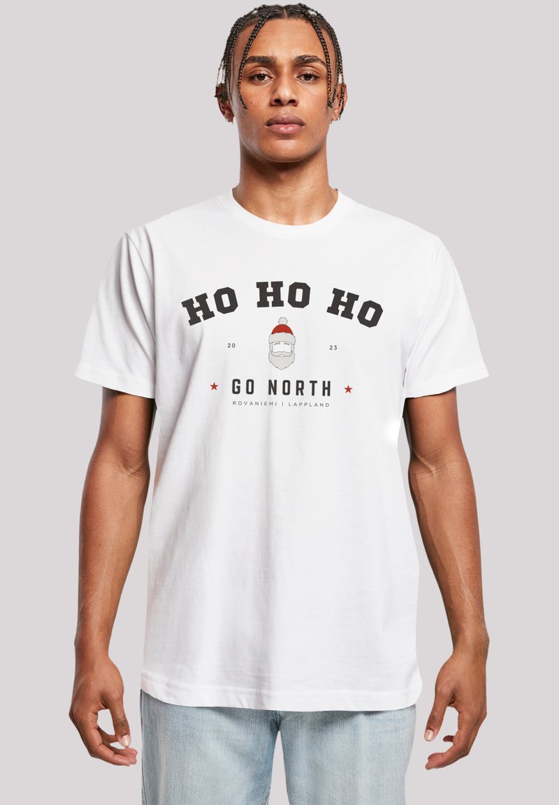 White cotton t-shirt featuring a graphic print with "HO HO HO" text, a Santa illustration, and "GO NORTH" in bold black letters beneath.