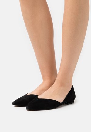 Mocasini din suede negru, cu vârf ascuțit și design în formă de V. Textură mată și toc joasă, potrivite atât pentru ținute casual, cât și pentru cele formale.