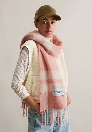 Pink and white checked scarf made of soft fabric, with fringed edges and a tag labeled "Marc O'Polo DENIM." Worn over a cream vest.