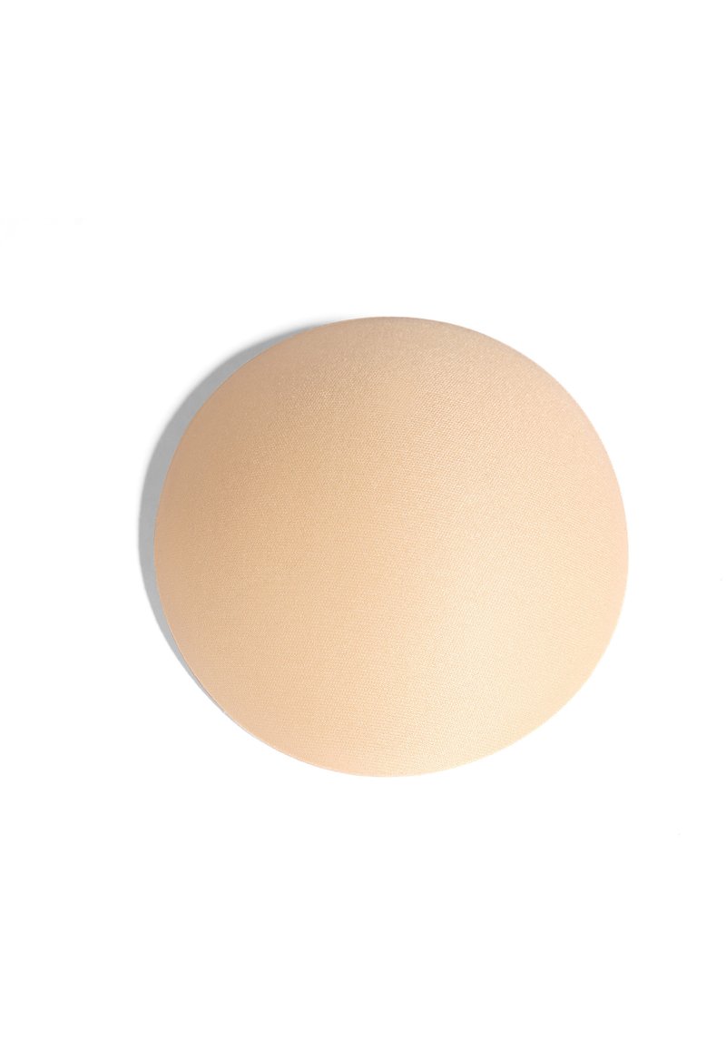 Okrąła, brzoskwiniowa podkładka silikona o gładkiej teksturze i matowym wykończeniu, zaprojektowana do bezszwowej integracji na różnych powierzchniach.