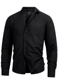 Chemise noire à boutons en coton. Elle présente un col pointu, des manches longues, une poche poitrine unique et une coupe régulière.