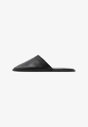 Black leather slide sandal with a pointed toe and minimalist design. Smooth texture with a flat sole and no visible hardware.