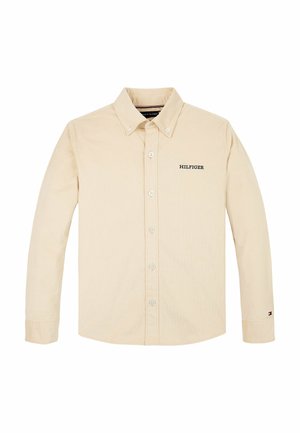 Beżowa koszula na długi rękaw zapinana na guziki, z kołnierzykiem na guziki oraz napisem „HILFIGER” na lewym biuście i małym logo na lewym mankiecie.