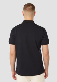 Zwart poloshirt van katoen, korte mouwen, met een kraag met twee knopen en contrasterende afwerking op de mouwen. Zachte textuur.