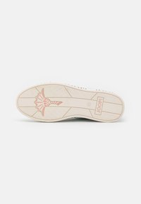 White sneaker sole featuring a pink floral design, textured grooves, and branding. Smooth rubber material with a subtle sheen.