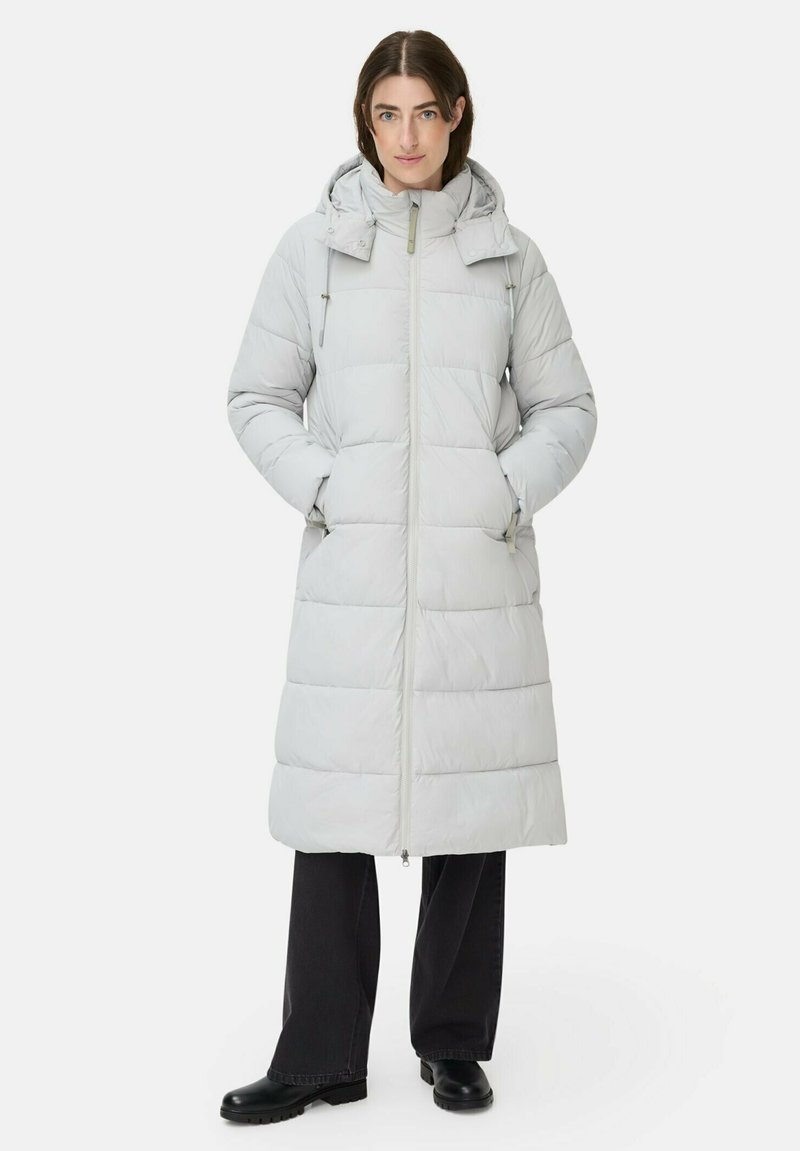 Lang lys grå pufferjakke med hætte, lynlås foran og elastiske snore. Har en quiltet design og sidelommer.