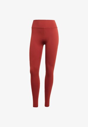 Visoko pasovi rdeči leggingi, narejeni iz gladkega, raztegljivega materiala. Imajo prilagojeno zasnovo z ravnimi šivi in brez vidnih kovinskih delov.