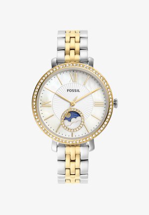 Montre Fossil avec un bracelet en métal bicolore, or et argent. Cadran rond avec un fond en nacre, accents en pierres et fonction phase de lune.