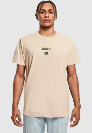 Beige cotton t-shirt with black text "ABSOLUTELY NOT." printed centrally. Classic crew neckline and short sleeves; relaxed fit.