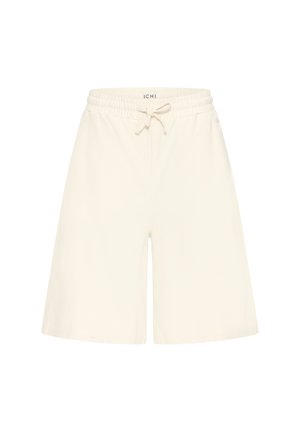 Kreemivärvilised põlveni ulatuvad lühikesed püksid elastse vöökohaga ja esikinnitusega nööriga, millel on küljetaskud ja lõdvestatud lõige.