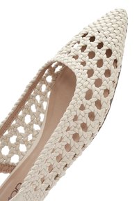 Pointed-toe flat shoe made of beige woven material, featuring cut-out patterns and a smooth interior lining for added comfort.