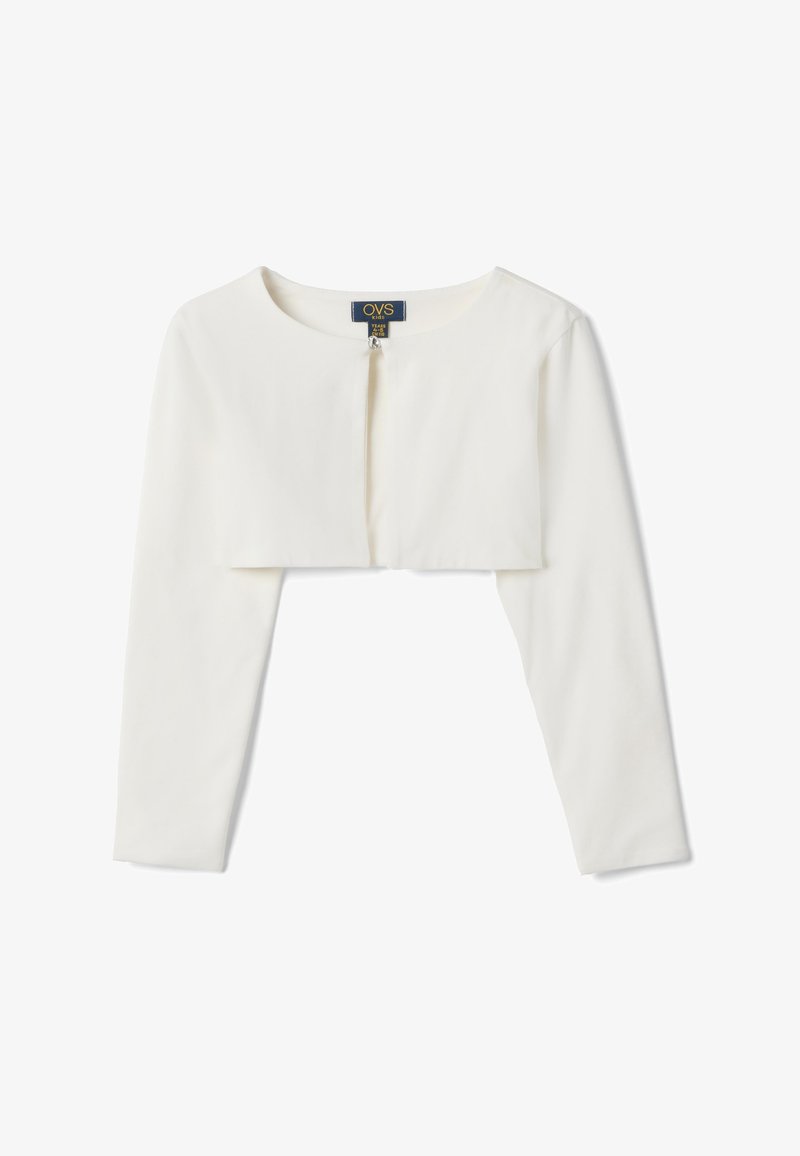 Boléro blanc à manches longues, court, avec un col rond et une fermeture par un seul crochet, conçu pour les enfants, posé à plat sur un fond blanc.