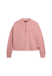 Sudadera corta en rosa pálido con cuello henley, cuenta con tres botones, mangas largas y un pequeño logotipo bordado en el pecho.