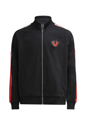 Black zip-up track jacket with red and white stripes on sleeves, snap buttons along red panels, and red horseshoe logo on left chest.
