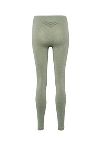 Legginsy z wysokim stanem, bezszwowe, jasnozielone z teksturowanym trójkątnym wzorem na tylnej gumce, widoczne od tyłu.