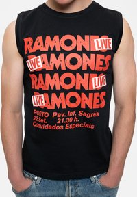 Black sleeveless t-shirt featuring bold red text "RAMONES LIVE" with concert details underneath, displayed in a distressed font.
