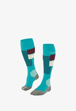 Calze al ginocchio di un vivace colore turchese con motivi geometrici, dettagli color borgogna e una sezione grigia per il piede. Realizzate in un materiale testurizzato.