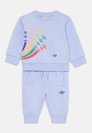 Light blue sweatshirt and matching jogger set, featuring a multicolored graphic of leaves. Material is soft; joggers have drawstring and pockets.