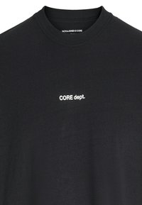 Black short-sleeve t-shirt made of cotton with a crew neck, featuring white text reading "CORE dept." on the left chest area.