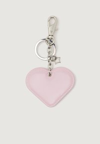 Rózsaszín szív alakú kulcstartó ezüst csattal, karikával és egy kis csillag alakú charm-mal egy sima világos háttéren.