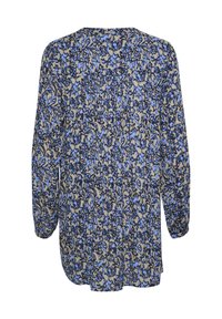 Blouse à manches longues avec un motif floral bleu et noir sur fond beige. Tissu doux, coupe décontractée, ourlet arrondi et accents de boutons.