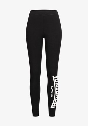Schwarze Leggings aus dehnbarem Stoff, mit einem weißen Logo-Druck am linken Bein, einem hohen Taillenbund und einer glatten Textur.