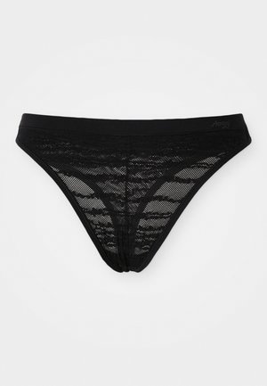 Svart blond thong med et gjennomsiktig, mønstrete design, myk midjebånd og minimal dekning. Har en logo trykket på midjebåndet.