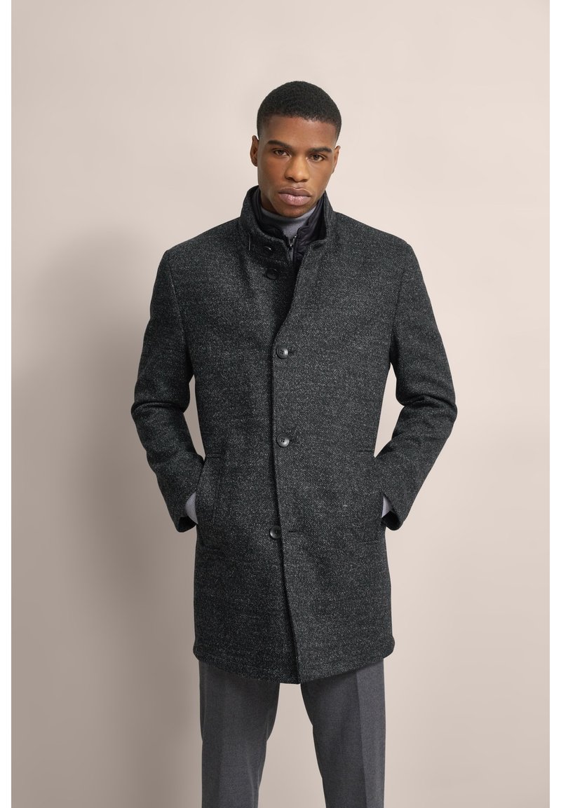 Cappotto in misto lana grigio con colletto alto, chiusura a bottoni e tasche laterali, con una finitura testurizzata e un design dritto.