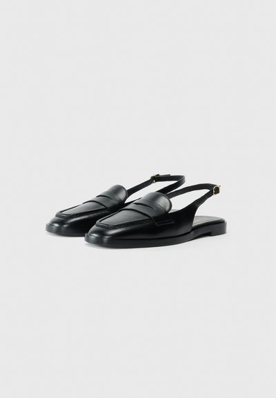 Scarpe slingback nere realizzate in pelle liscia, con un pannello frontale imbottito e una suola piatta con un discreto dettaglio a fibbia sul cinturino.