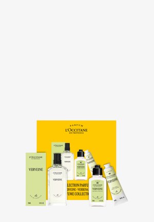 L'Occitane Verveine collection with eau de toilette, perfumed shower gel, and hand cream displayed with green and yellow packaging.