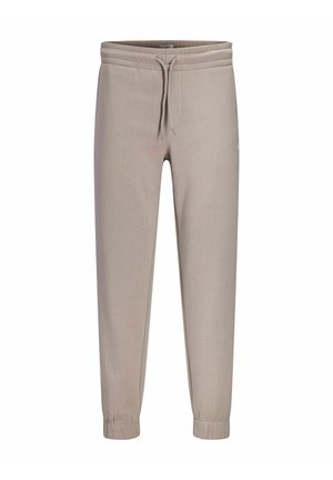 Beige joggingsbroek met elastische tailleband, trekkoord, zijzakken en elastische boorden bij de enkels.