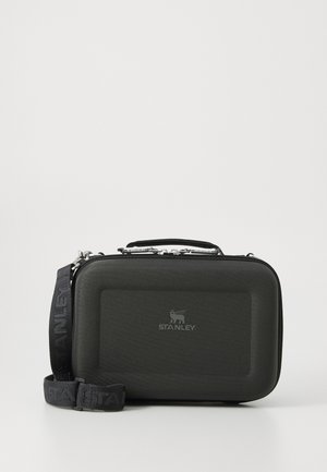 Black hard case with a textured exterior, a top handle, and a detachable strap. Features a silver zipper and an embossed logo on the front.
