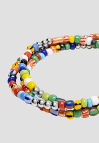 Colorful beaded bracelet featuring multi-colored glass and metal beads arranged in a twisted design, showcasing varied shapes and textures.