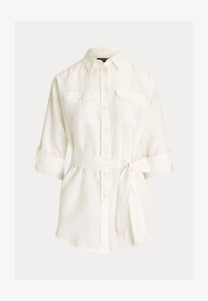 Valge linane särk nööbitava kraega, kahe ees taskuga, ülesrullitavaid varrukaid ja ise siduvat vöökohta. Sile ja kerge tekstuur.