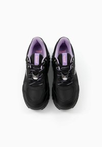 Black sneakers with purple accents, textured material, round toe, and patterned laces featuring a character charm on the tongue.