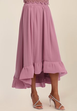 Flowy mauve midi skirt with ruffled hem paired with silver high-heeled sandals featuring thin, sparkling straps.