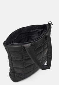 Svart vadderad tote-väska med quiltad textur, dubbla bärhandtag och ett blixtlås ovanpå. Inuti finns fickor för organisation.