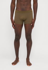 Dark olive green boxer briefs with a snug fit, crafted from soft material, featuring a flat waistband and minimal seam detailing.