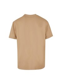 Beige bomulds t-shirt med rund hals og korte ærmer, med en simpel tekstur og en udekoreret ryg.