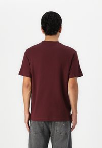 Lacoste Marškinėliai su spaudiniu - expresso