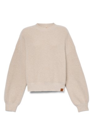 Beige kort tröja med ribbad textur, breda ärmar och rund halsringning. Har en liten läderlogotyp på nederkant.
