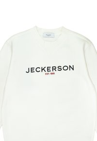 Cream sweatshirt with a v-neck design. Features black embroidered text "JECKERSON" and "EST. 1995" in a contrasting red hue.