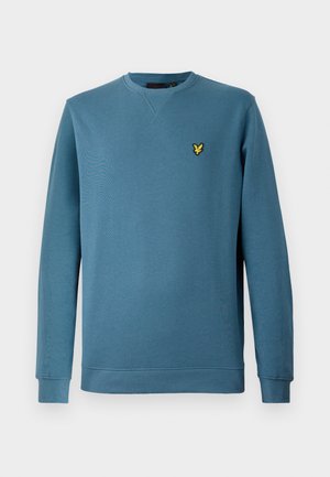 Blue long-sleeve crewneck sweatshirt with ribbed cuffs and hem, featuring a small yellow embroidered bird logo on the left chest.