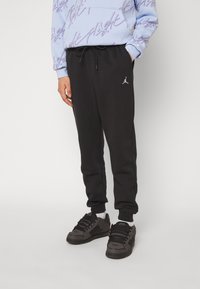 Jordan Pantaloni de trening - black/white